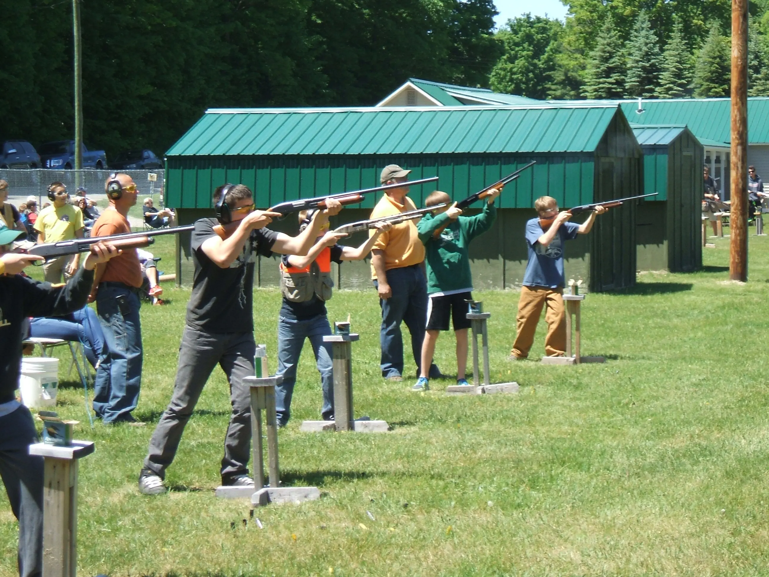 A group of people are practicing shooting at guns.